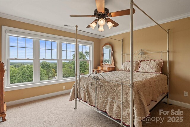 bedroom with baseboards, ornamental molding, carpet, and a ceiling fan