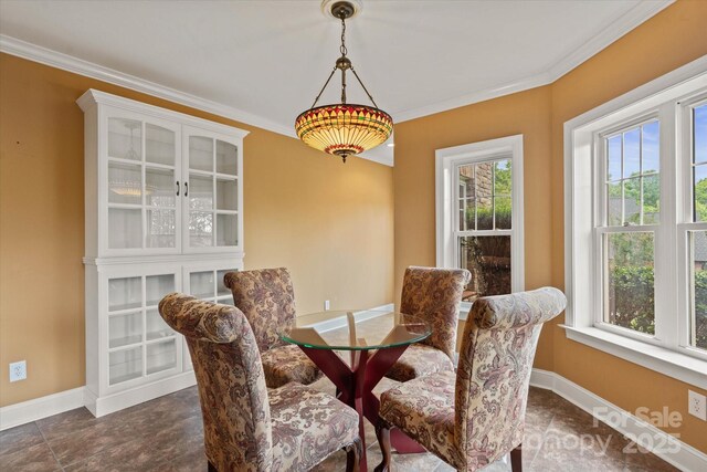 dining area with baseboards and crown molding
