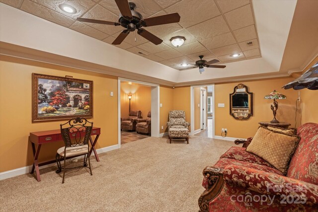 carpeted living room with ceiling fan and baseboards