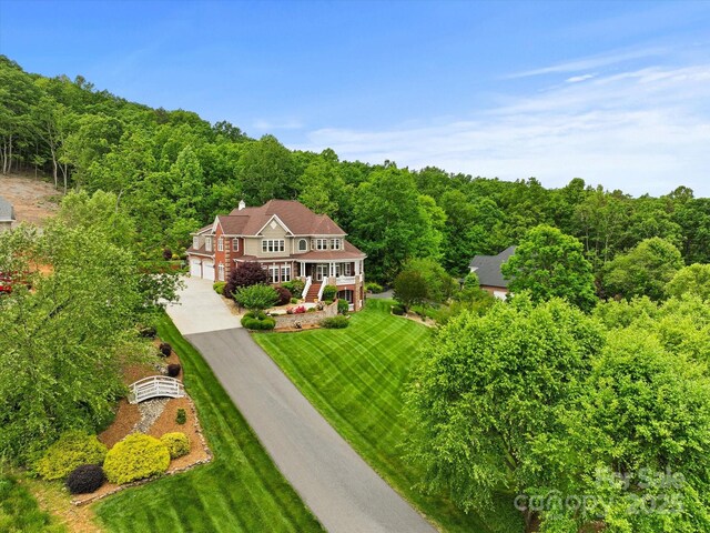 view of subject property featuring a heavily wooded area