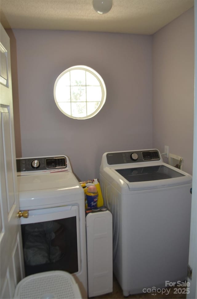 washroom with laundry area and washer and dryer