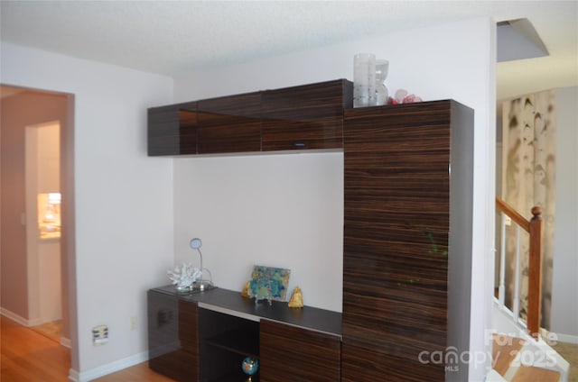 interior details with baseboards and wood finished floors