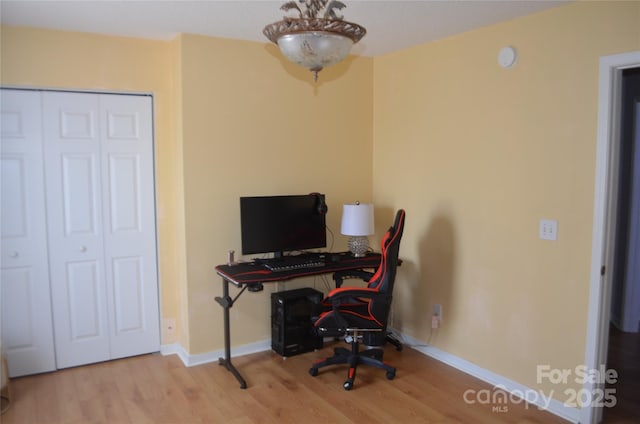 office space with baseboards and wood finished floors