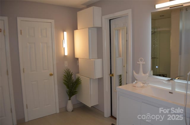 full bathroom featuring an enclosed shower, vanity, and wood finished floors