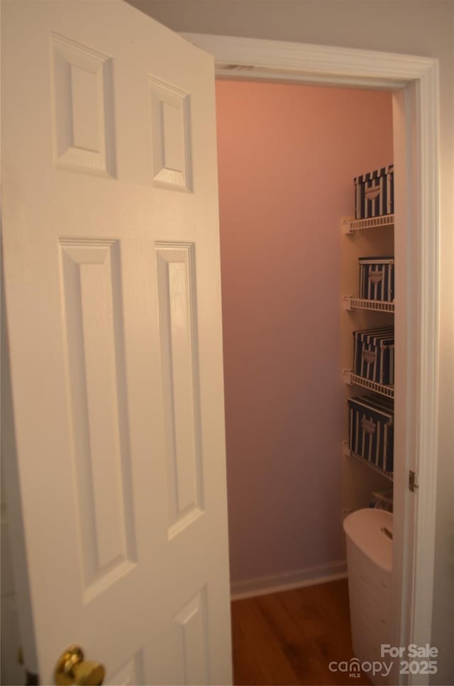 bathroom featuring baseboards and wood finished floors