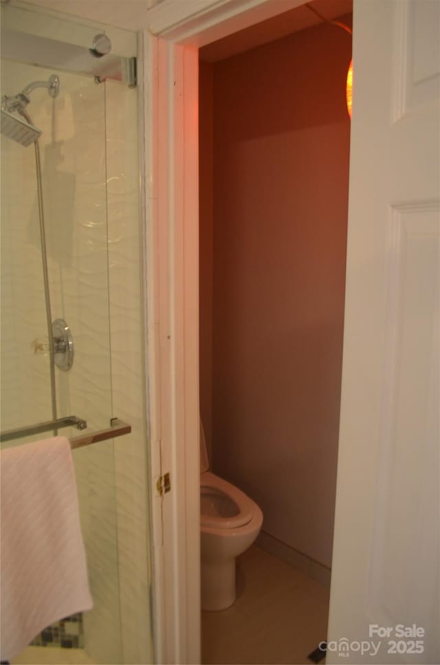 full bath with a stall shower and toilet