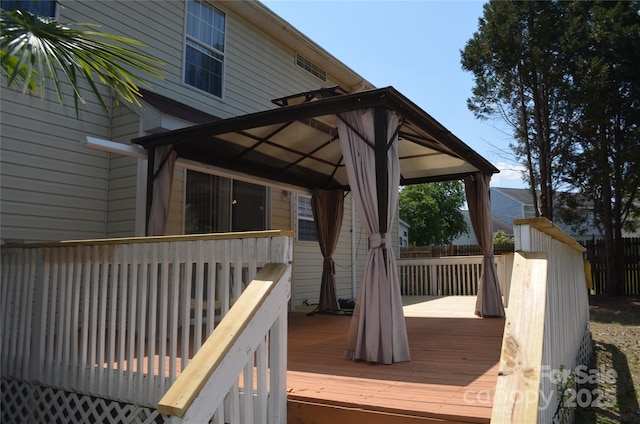 deck featuring a gazebo and fence