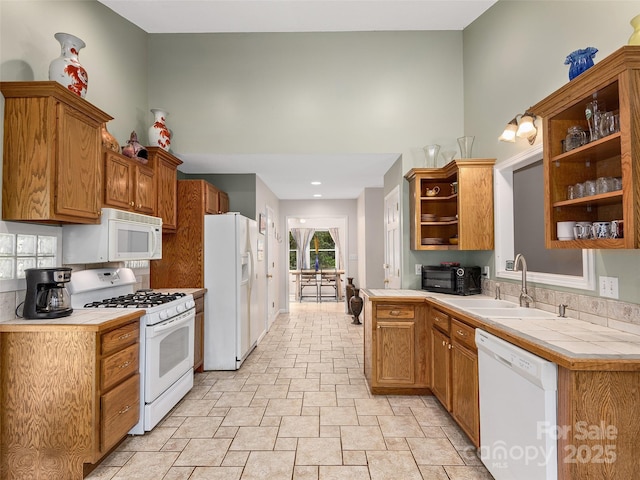 221 Holland Dr, Black Mountain, NC 28711 - kitchen with a sink, white appliances, a towering ceiling, open shelves, and tile counters