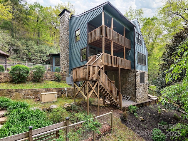 221 Holland Dr, Black Mountain, NC 28711 - rear view of house with fence, a balcony, stone siding, a chimney, and stairway