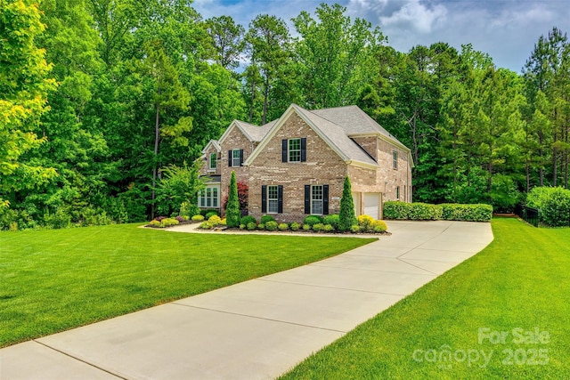 colonial house featuring brick siding, driveway, a front yard, and an attached garage