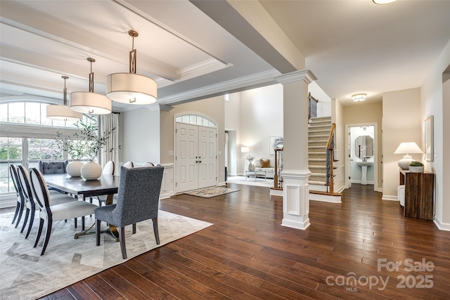 dining area with decorative columns, dark wood-type flooring, ornamental molding, stairs, and baseboards