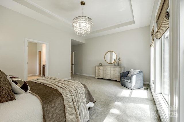 carpeted bedroom with multiple windows, a chandelier, a tray ceiling, and baseboards
