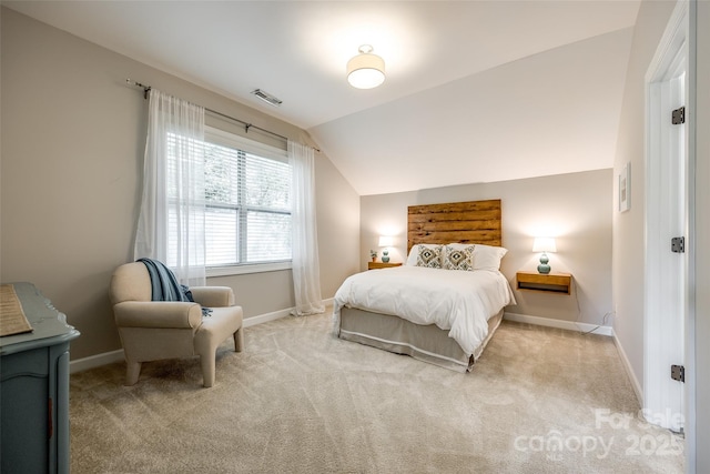 carpeted bedroom featuring lofted ceiling and baseboards