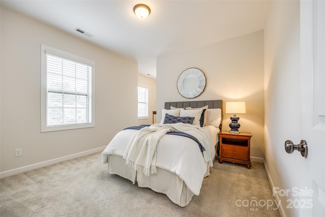 carpeted bedroom featuring baseboards