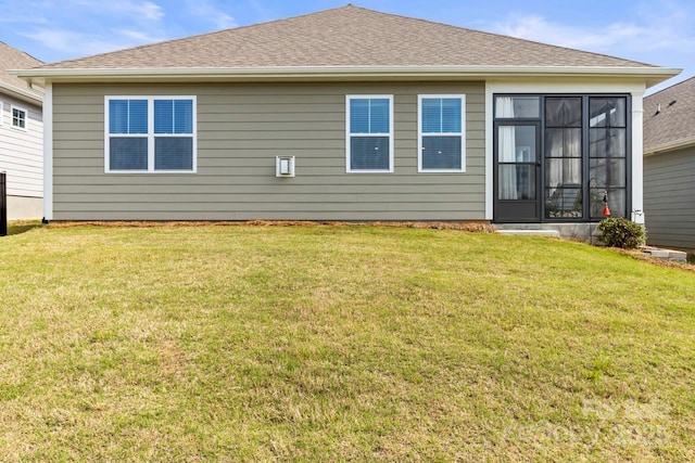 back of property featuring a lawn