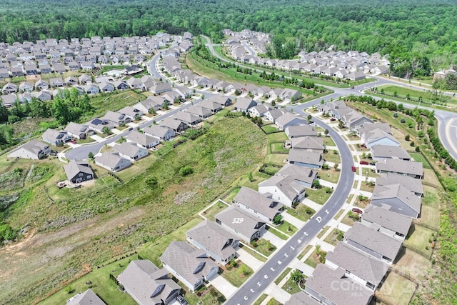 birds eye view of property with a residential view and a wooded view
