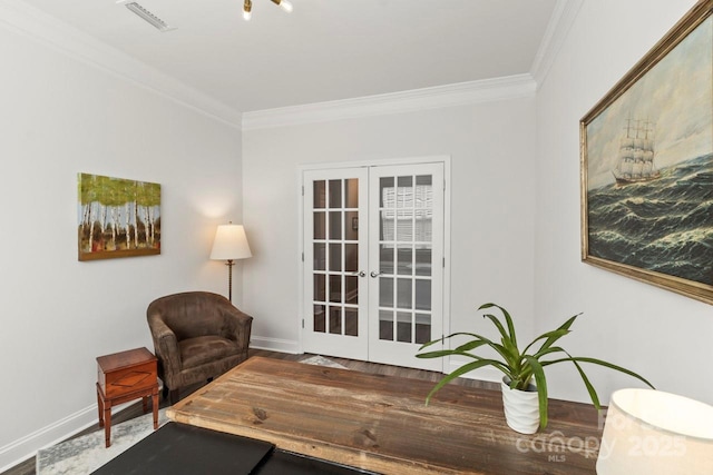 sitting room featuring crown molding, baseboards, visible vents, and french doors