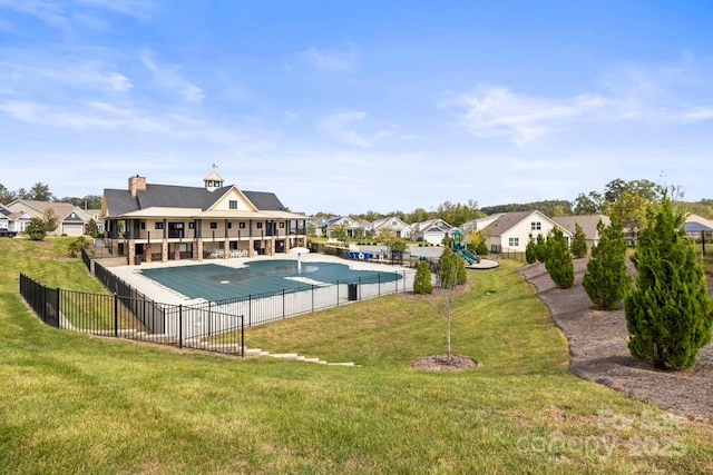 view of pool with a fenced in pool, a lawn, fence, and a residential view