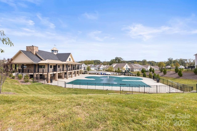 view of swimming pool with fence, a fenced in pool, and a lawn