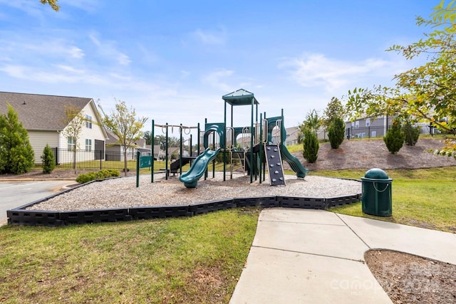 communal playground with a yard and fence