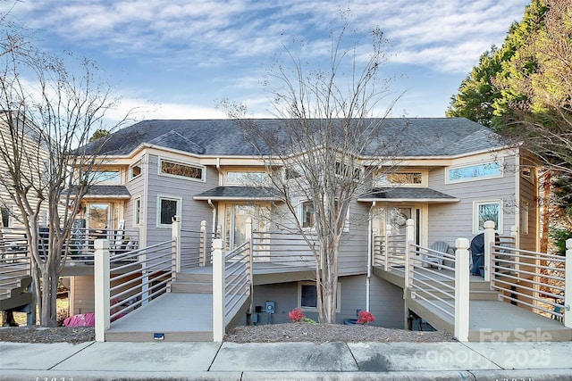 view of property with a shingled roof