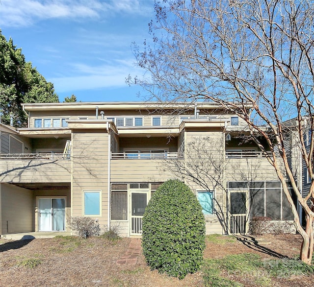 back of property featuring a balcony