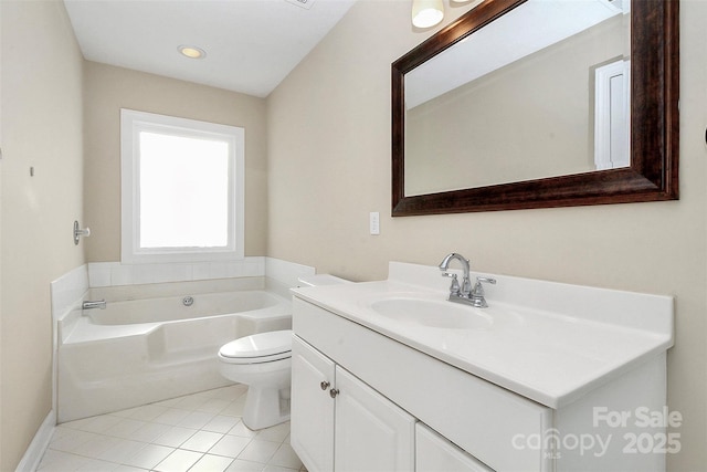 full bath featuring vanity, tile patterned floors, a bath, and toilet