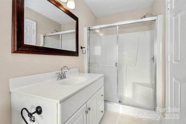 bathroom with tile patterned floors, a shower stall, and vanity