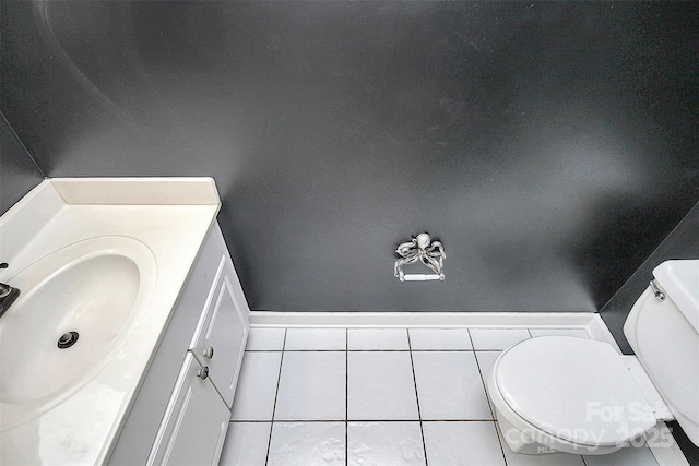 bathroom featuring vanity, tile patterned floors, and toilet
