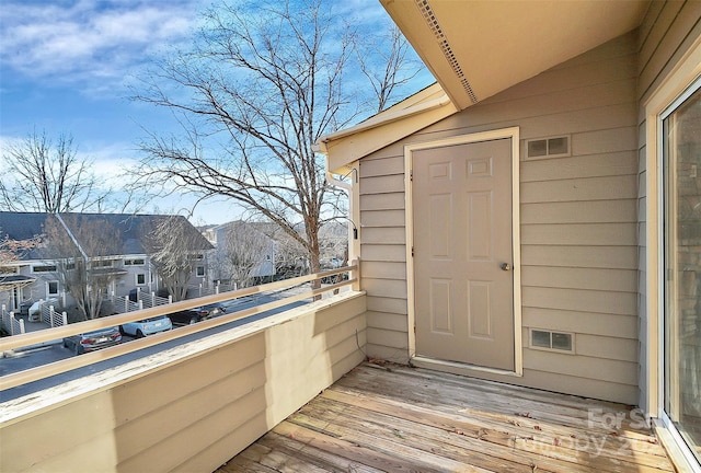 exterior space featuring visible vents, a balcony, and a residential view