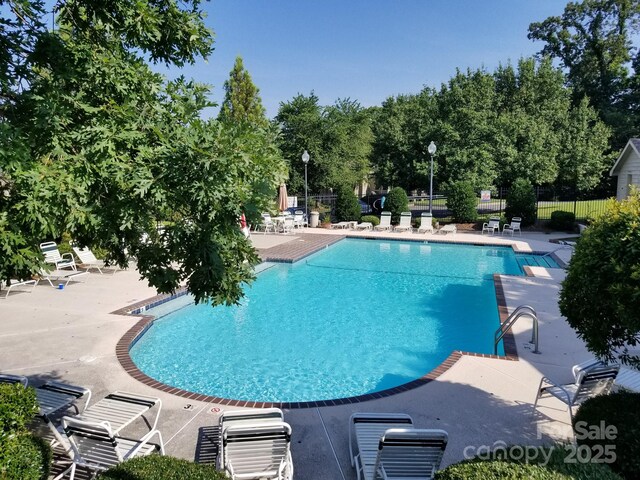 13932 Queens Harbor Rd, Charlotte, NC 28278 - community pool with a patio area and view of scattered trees