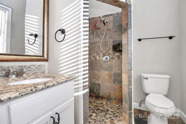 13932 Queens Harbor Rd, Charlotte, NC 28278 - bathroom featuring a walk in shower, toilet, vanity, and baseboards