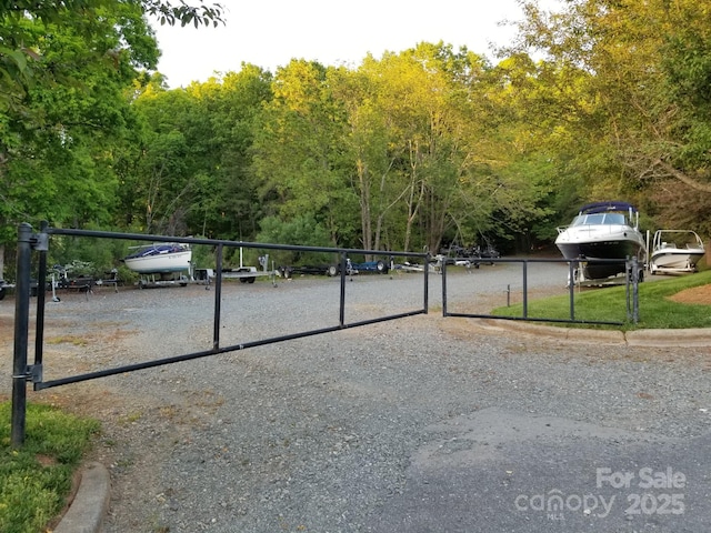 13932 Queens Harbor Rd, Charlotte, NC 28278 - view of dirt / gravel road featuring a gated entry