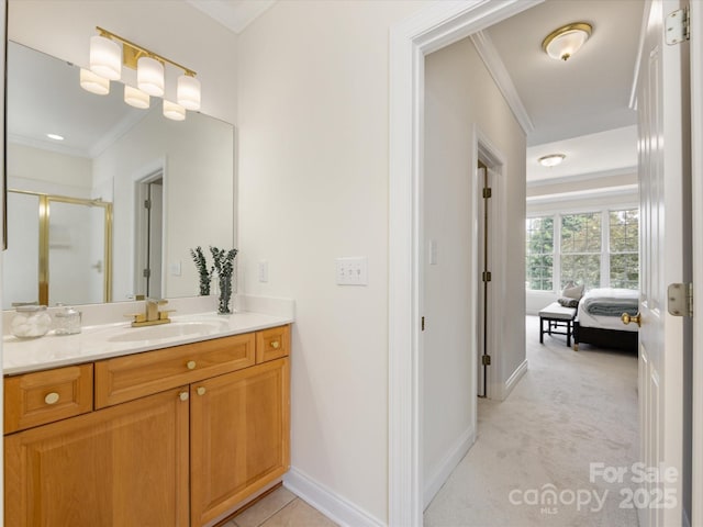 full bathroom featuring crown molding, ensuite bath, vanity, baseboards, and a shower stall