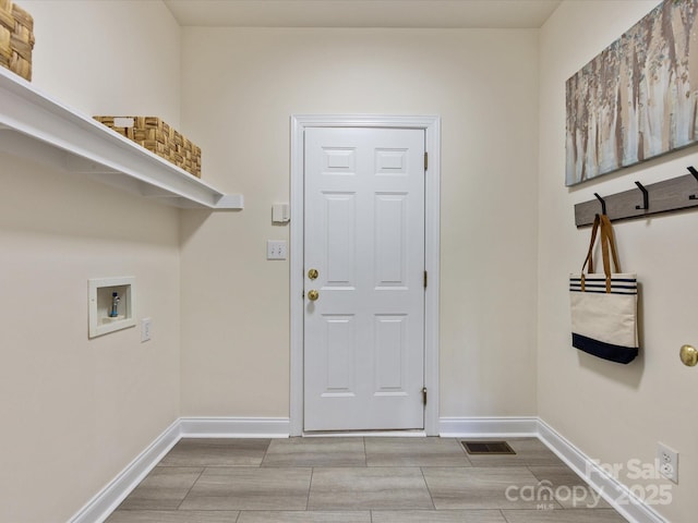 laundry area with washer hookup, wood tiled floor, laundry area, visible vents, and baseboards
