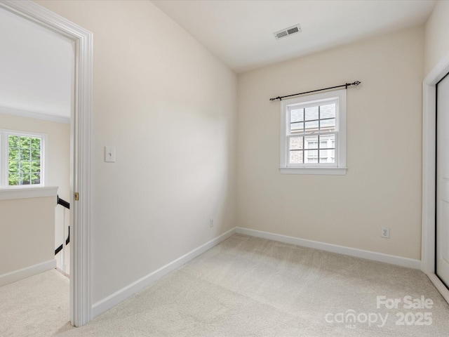 unfurnished bedroom with visible vents, carpet, and baseboards