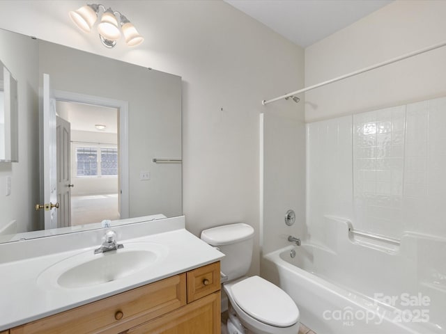 bathroom featuring toilet, shower / bath combination, and vanity