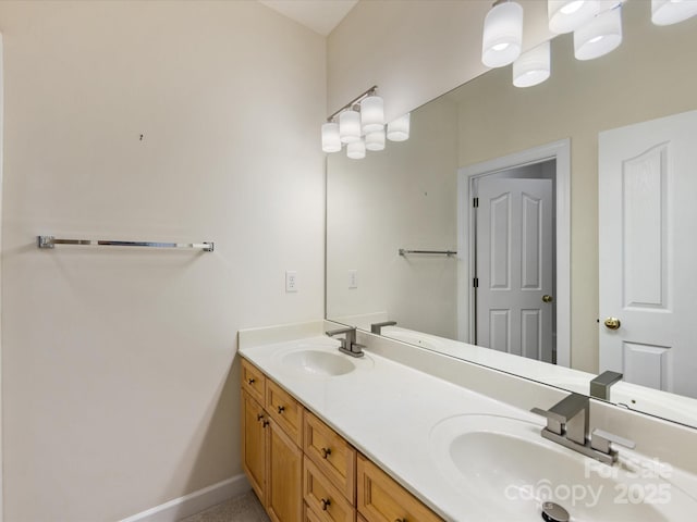 bathroom with double vanity, a sink, and baseboards