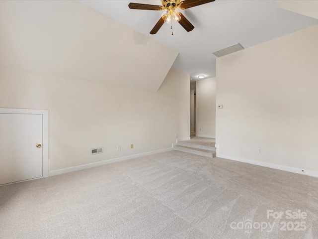 bonus room featuring visible vents, lofted ceiling, baseboards, light colored carpet, and a ceiling fan