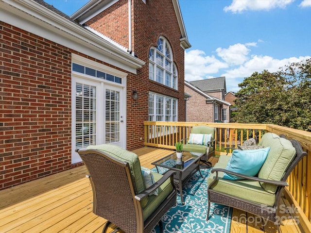 wooden deck with an outdoor living space