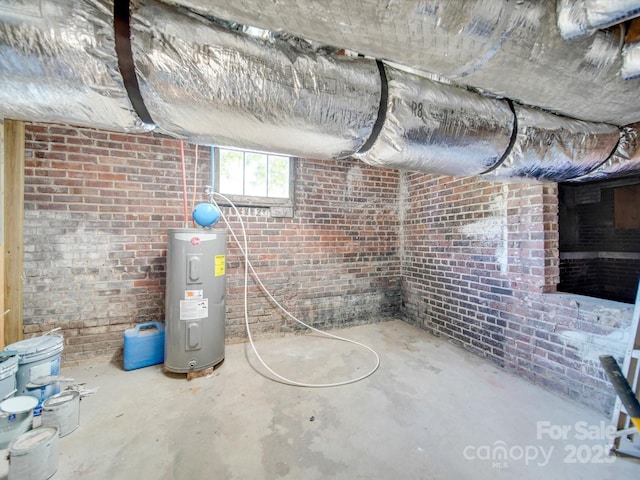 basement with water heater and brick wall