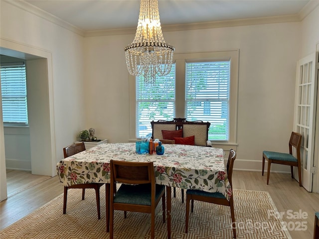 300 W Thomas St, Salisbury, NC 28144 - dining area featuring crown molding, light wood finished floors, baseboards, and a notable chandelier