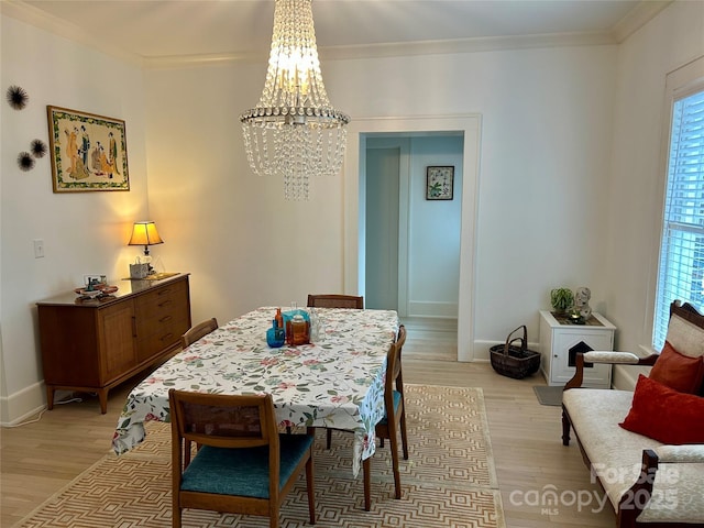 300 W Thomas St, Salisbury, NC 28144 - dining area featuring baseboards, ornamental molding, light wood-style flooring, and a notable chandelier
