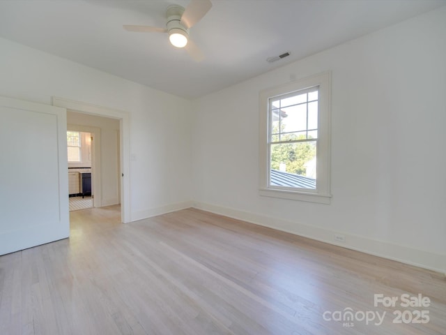300 W Thomas St, Salisbury, NC 28144 - unfurnished room with visible vents, light wood finished floors, ceiling fan, and baseboards