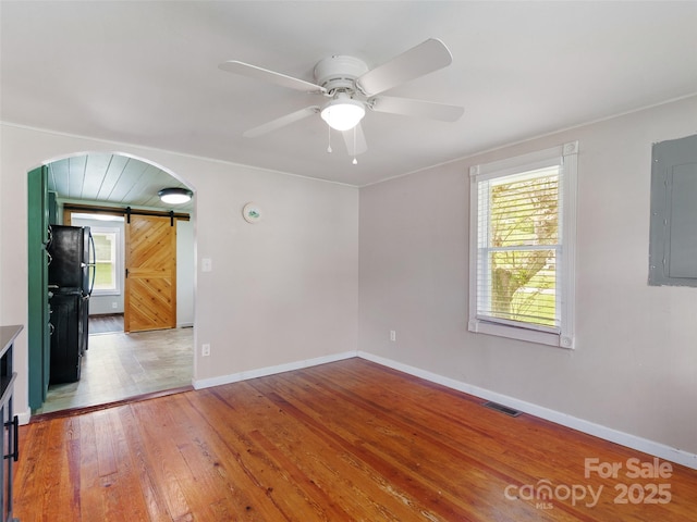 819 Mauney Cove Rd, Waynesville, NC 28786 - spare room featuring visible vents, a barn door, electric panel, and a wealth of natural light
