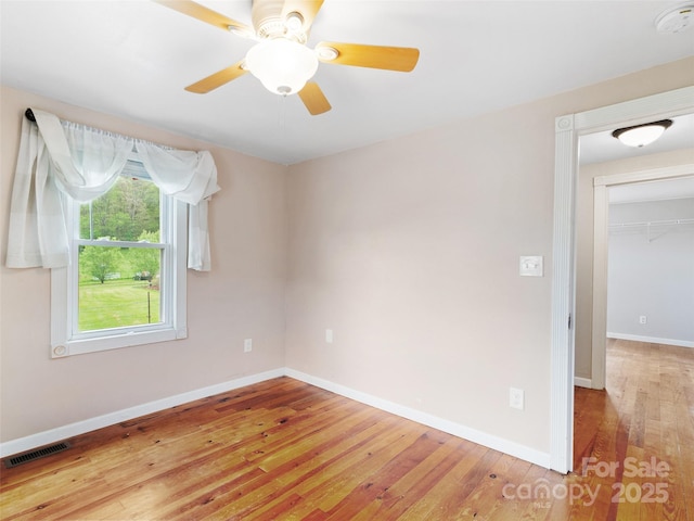 819 Mauney Cove Rd, Waynesville, NC 28786 - spare room with a ceiling fan, baseboards, visible vents, and light wood-type flooring