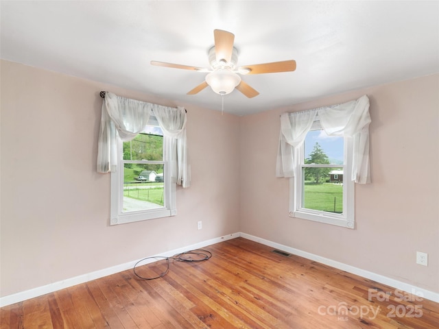 819 Mauney Cove Rd, Waynesville, NC 28786 - spare room with a ceiling fan, baseboards, visible vents, and a wealth of natural light