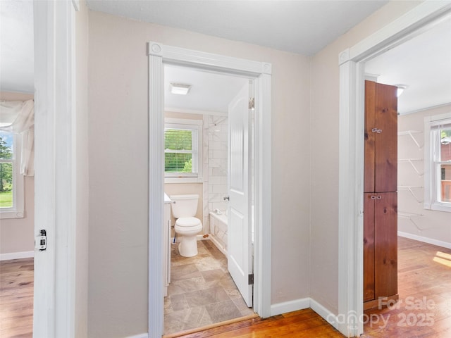819 Mauney Cove Rd, Waynesville, NC 28786 - full bath featuring toilet, baseboards, and wood finished floors