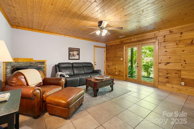 1415 Little River Campground Rd, Pisgah Forest, NC 28768 - living area featuring light tile patterned floors, a ceiling fan, ornamental molding, and wood walls