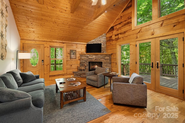 1415 Little River Campground Rd, Pisgah Forest, NC 28768 - living room featuring high vaulted ceiling, a stone fireplace, wooden walls, wood ceiling, and wood finished floors